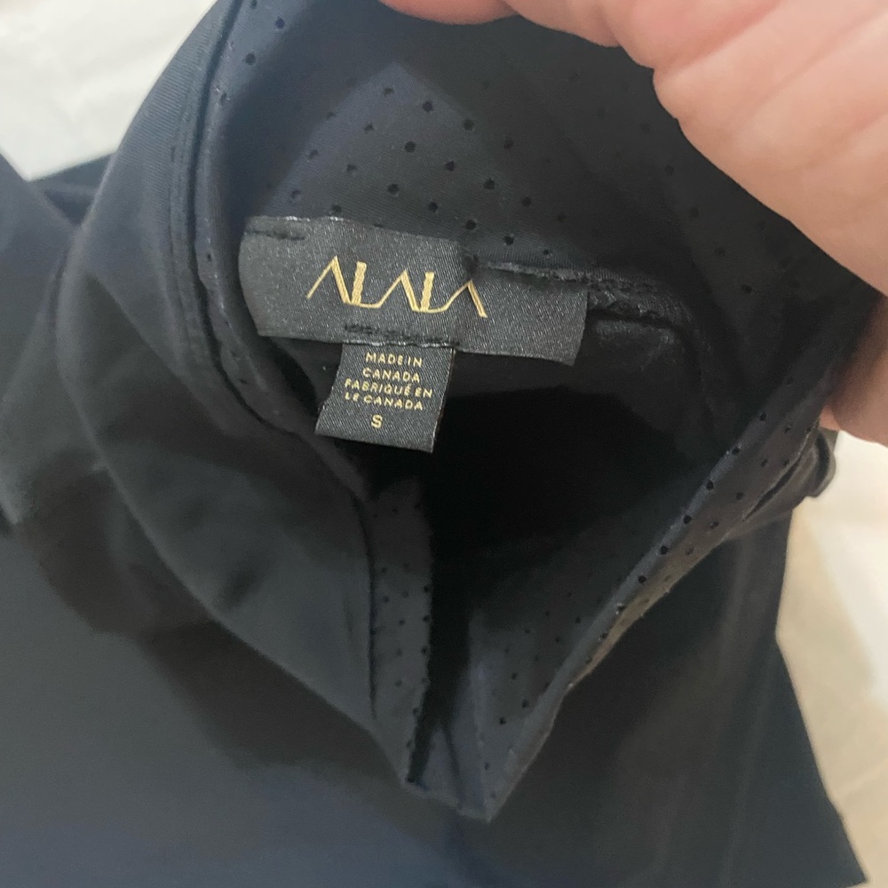 Alala brand run swiftly sweat wicking top for climate control running in weather